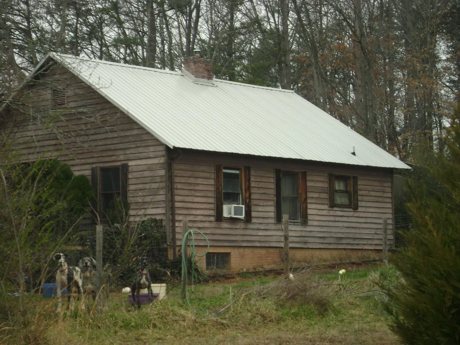 White metal roof on an old wood sided farmhouse, from a Metal Roof Installation job in Elliott